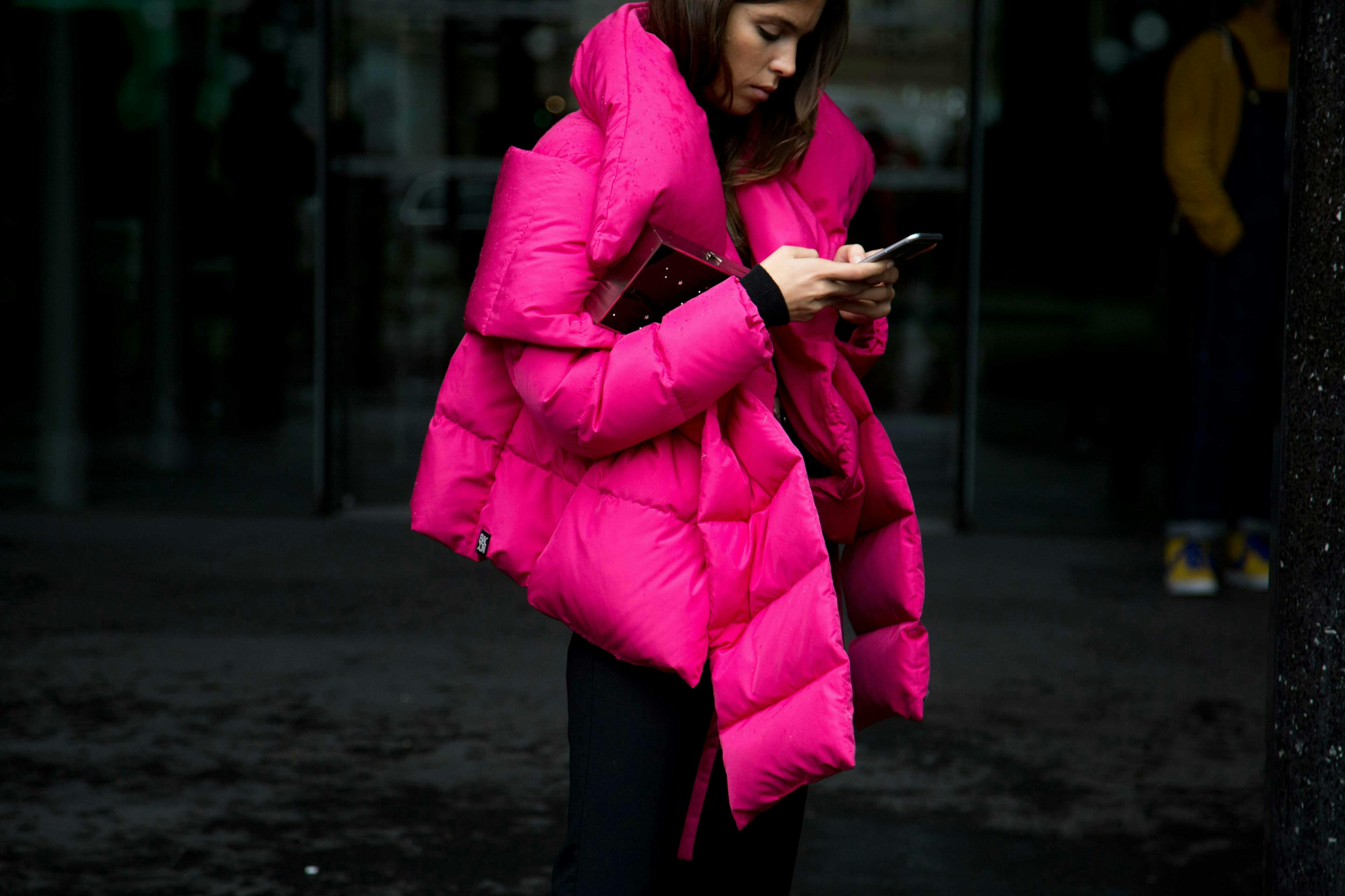 clothing apparel person human coat jacket overcoat phone electronics