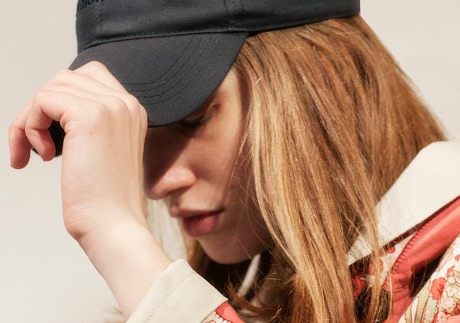 clothing apparel person human finger baseball cap hat cap