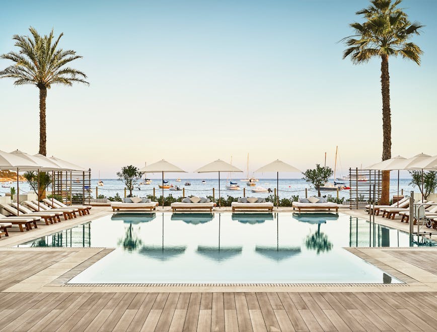 pool water hotel building resort palm tree plant arecaceae tree swimming pool