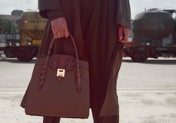 handbag bag accessories accessory clothing apparel overcoat coat person human