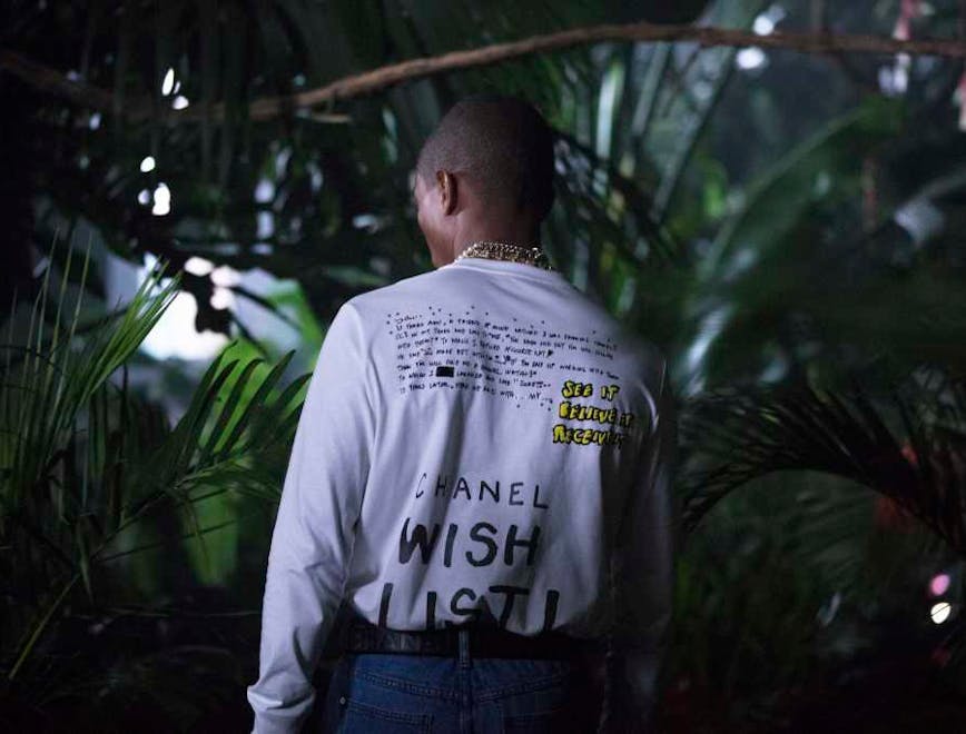 a still from the chanel-pharrell capsule collection film person human clothing apparel sleeve